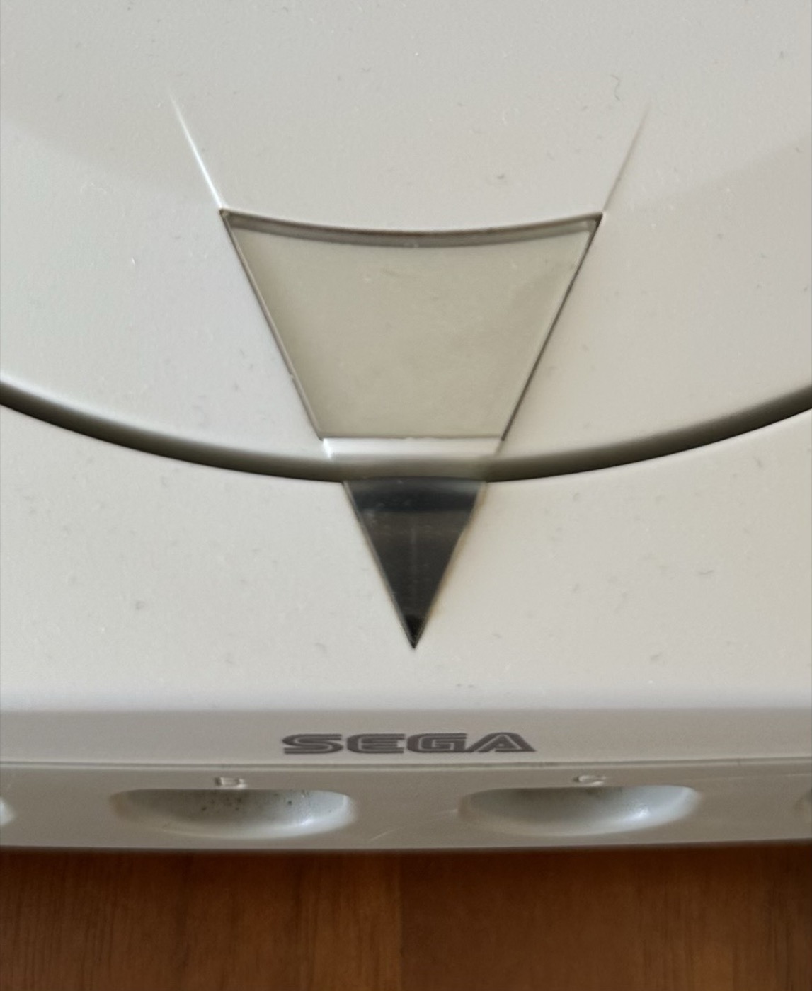 The opaque grey triangle badge on an NTSC-U Dreamcast lid