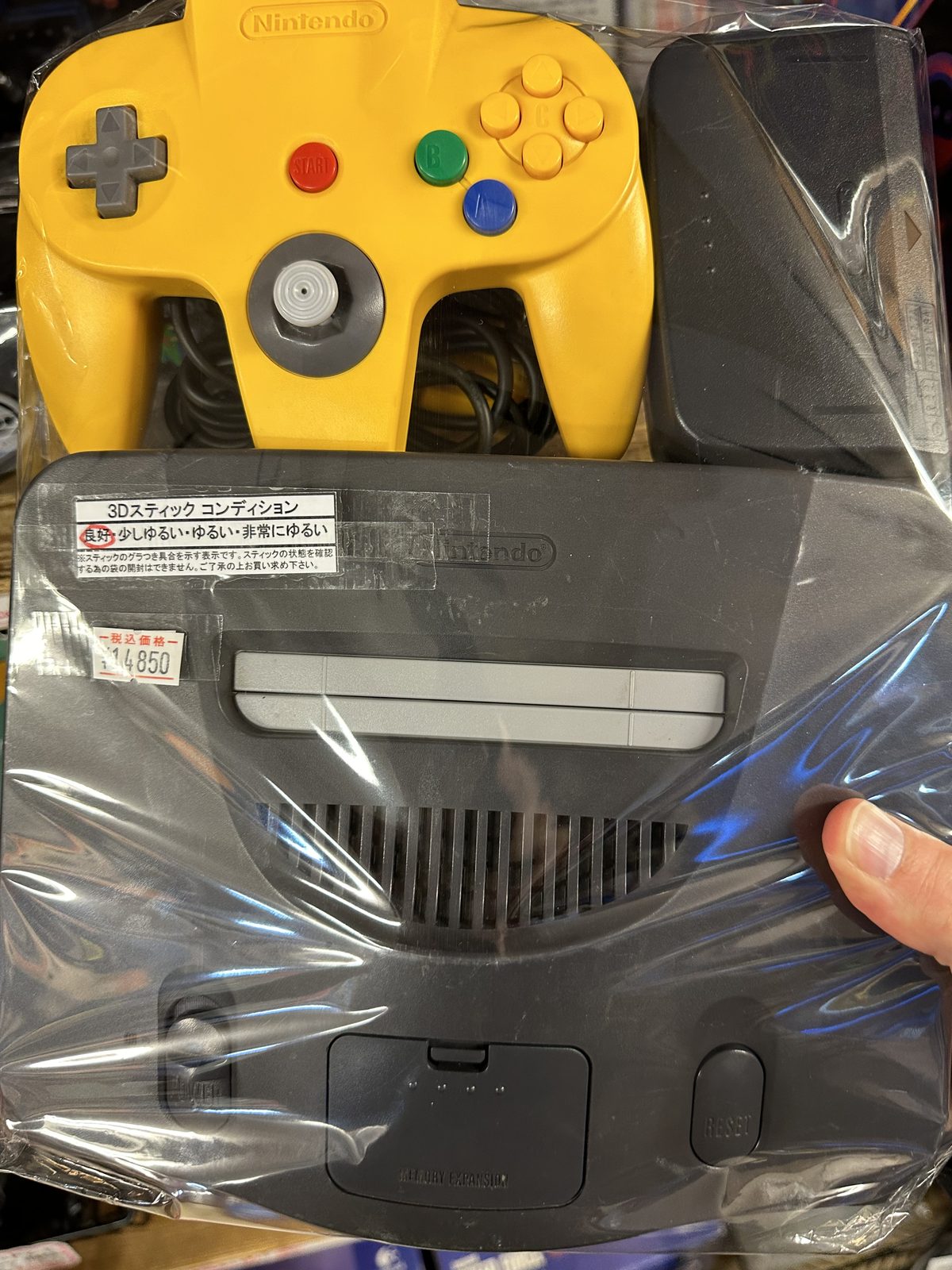 A loose Nintendo 64 and yellow controller at Super Potato, priced at ¥14,850