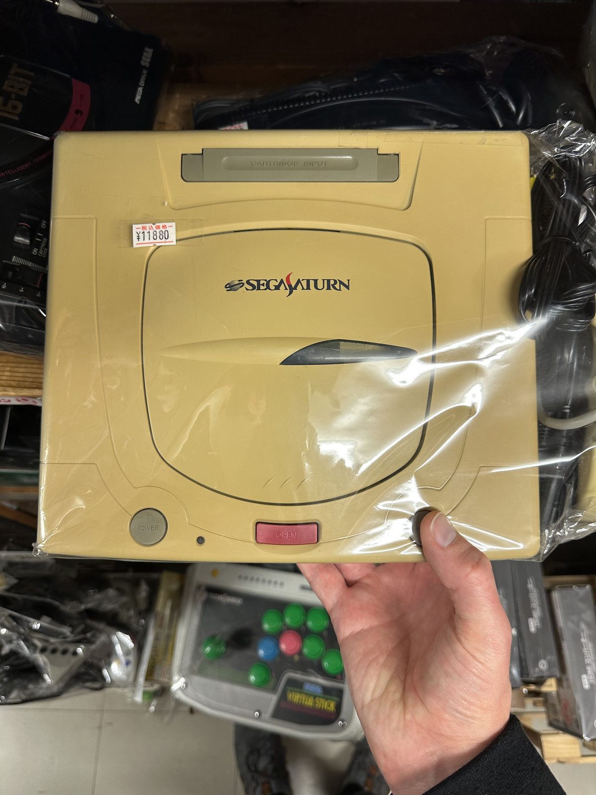 A heavily yellowed loose Sega Saturn at Super Potato, priced at ¥11,880