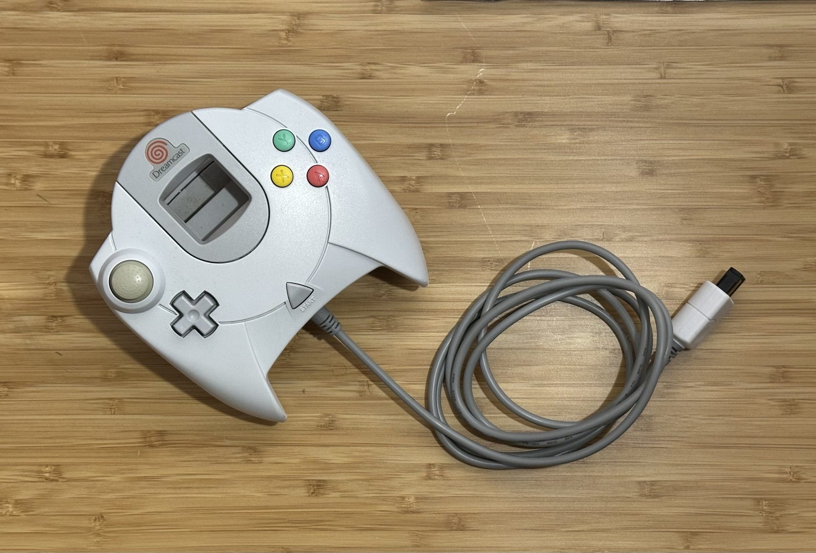 My Dreamcast controller after the repair, with its replacement cable coiled beside it