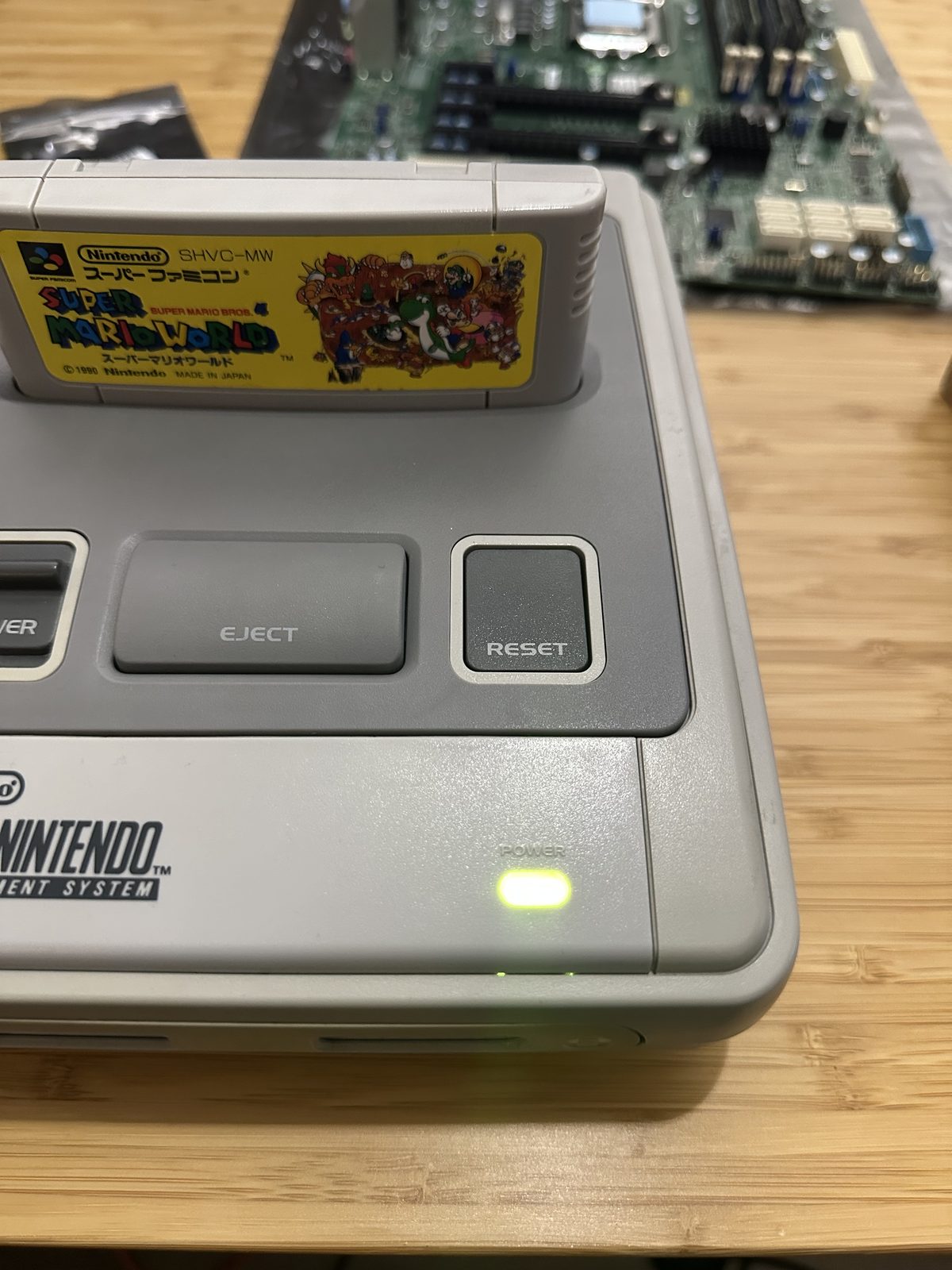 The green power LED lit next to the RESET button, cartridge in place