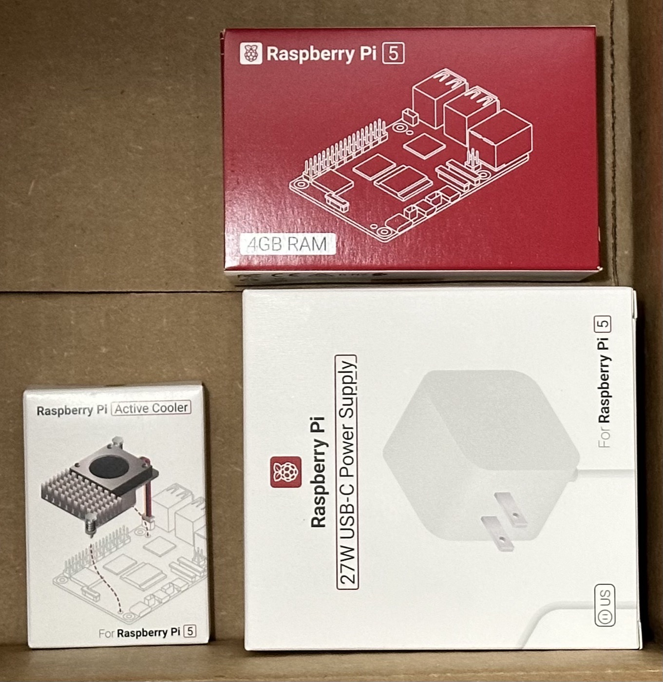 The Pi 5 kit as it arrived — 4GB board, official Active Cooler, 27W USB-C power supply
