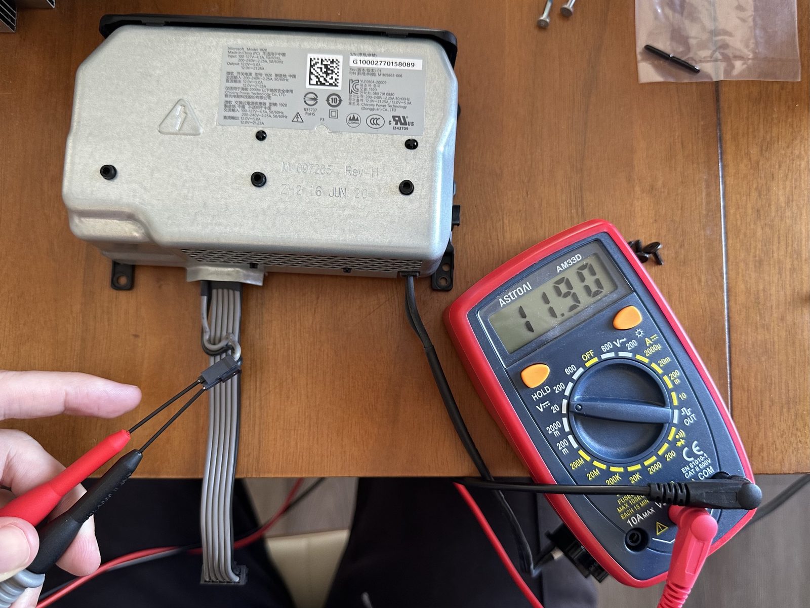 A multimeter reading 11.90V at the Xbox Series X PSU's output connector
