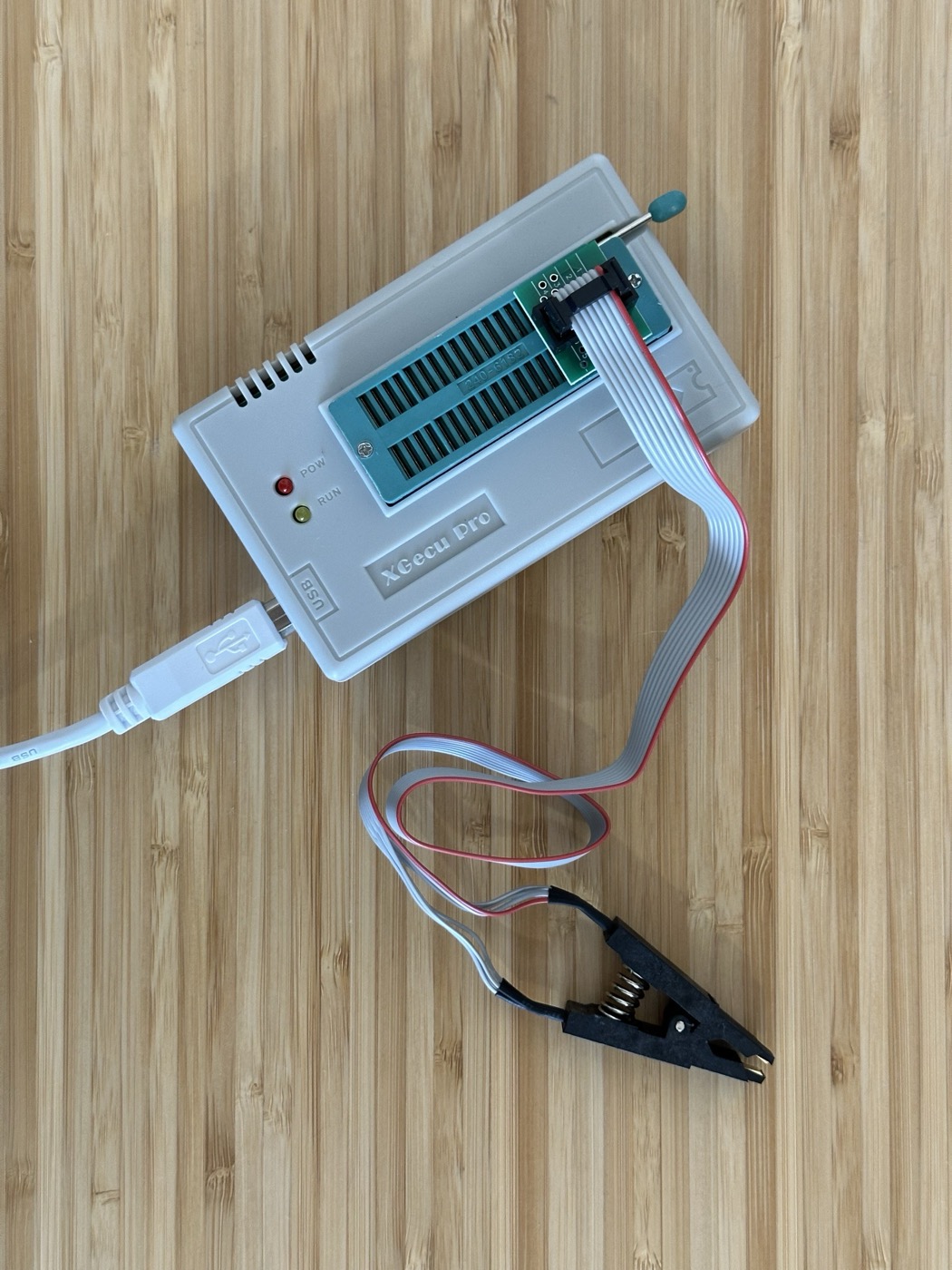 The XGecu Pro (TL866 II Plus) EEPROM programmer with its SOP8 test clip attached